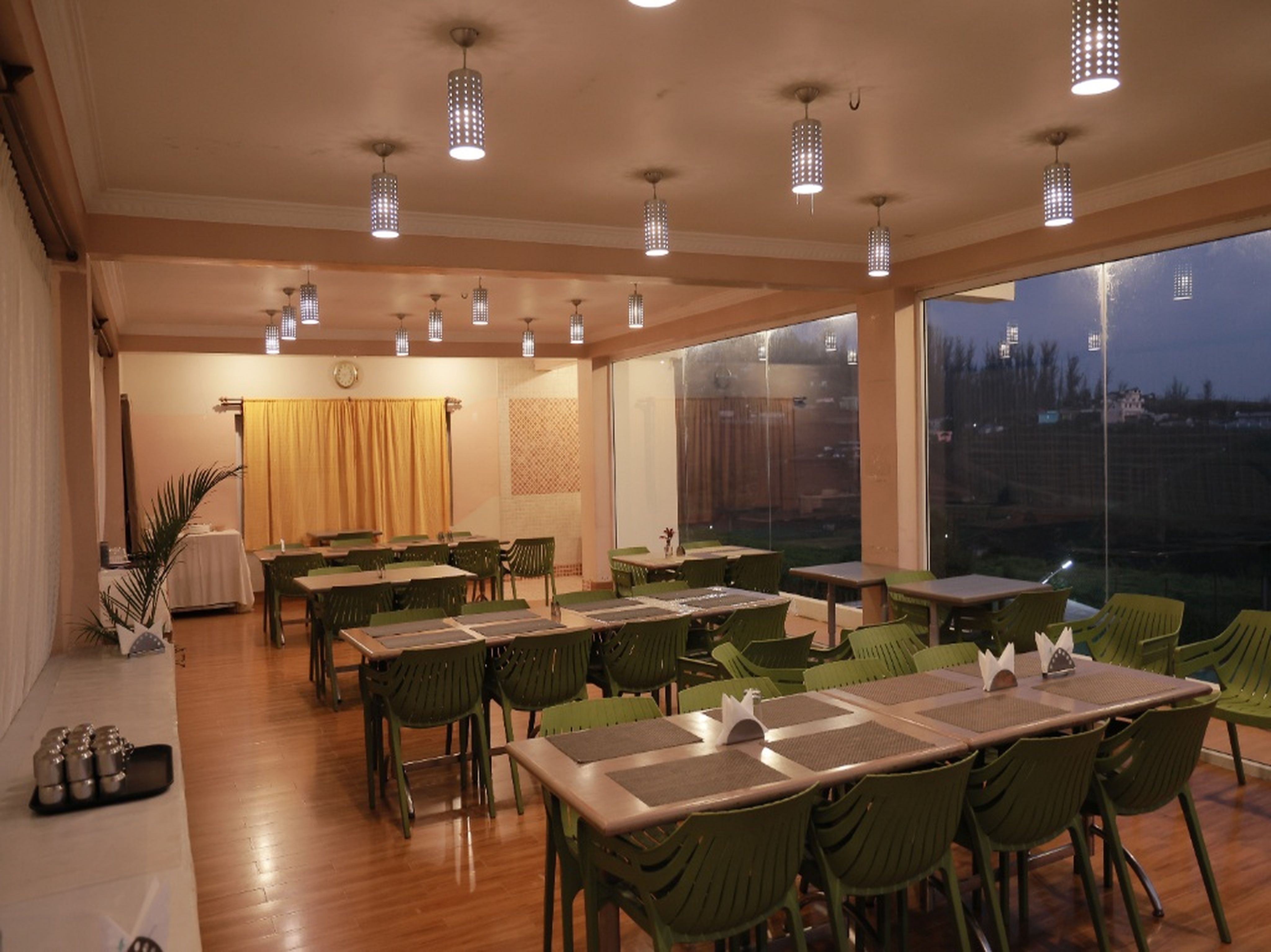 Modern multi-cuisine restaurant at a luxury resort with elegant seating, ambient lighting, and panoramic outdoor views.