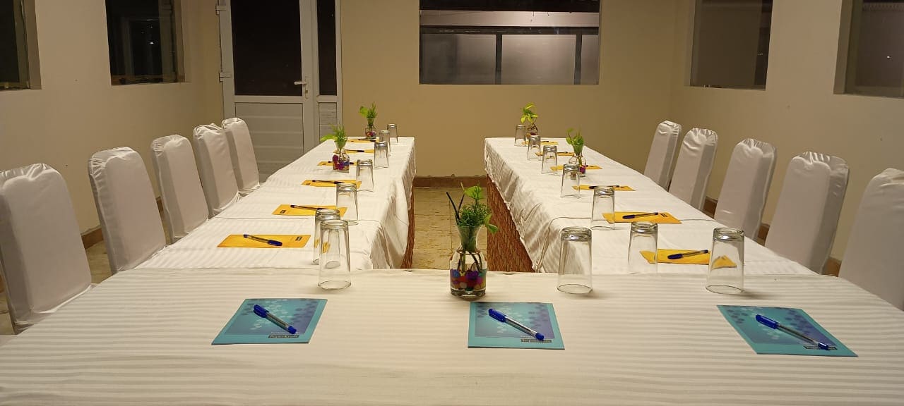 Modern conference room at LMS Palve Sugavasam Ooty with U-shaped seating, meeting tables, and business event setup.