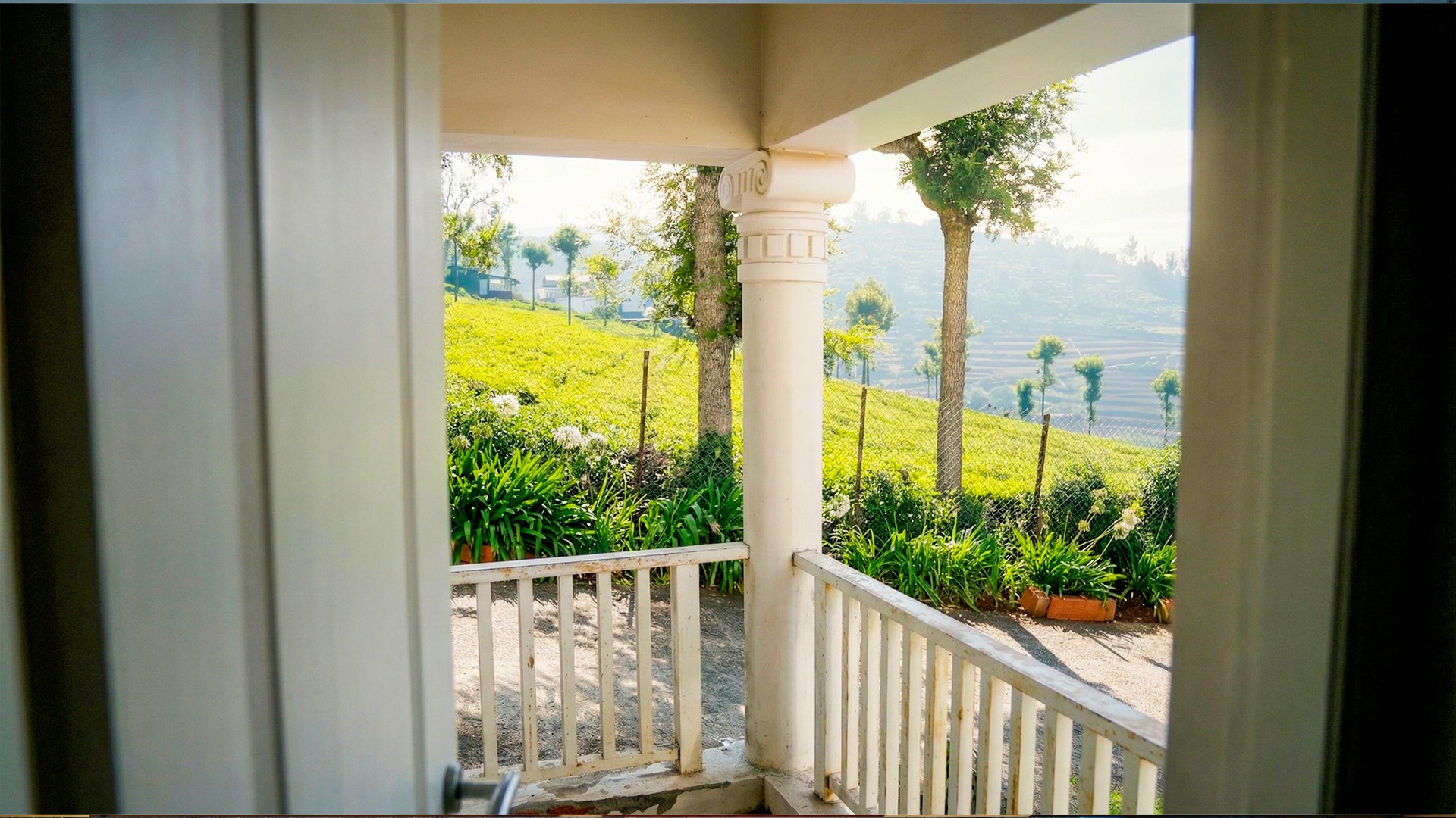 Scenic resort courtyard with stone staircase, landscaped gardens, and elegant accommodation buildings 