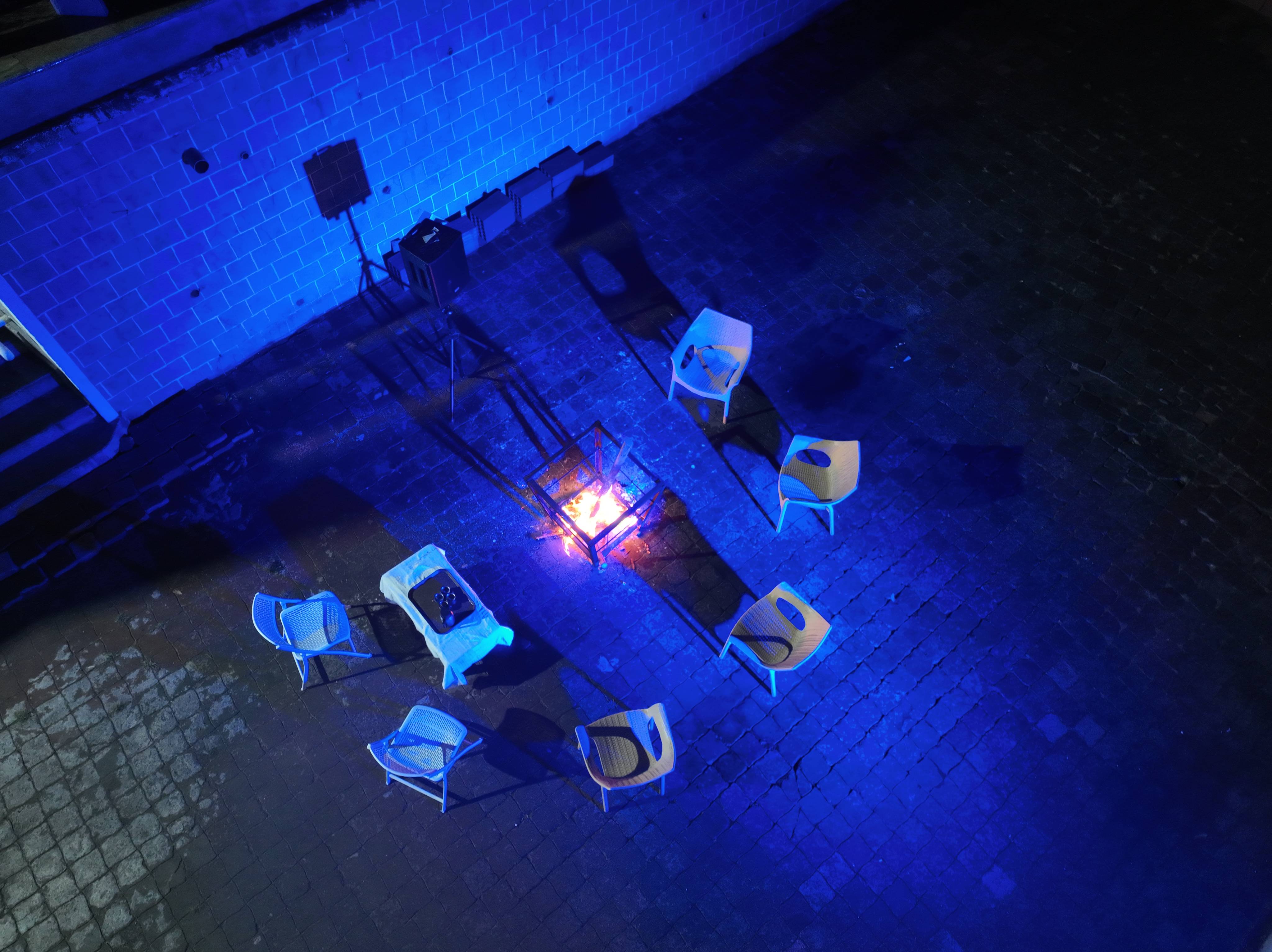  Outdoor bonfire seating area with chairs around a fire pit at a luxury resort during the evening 