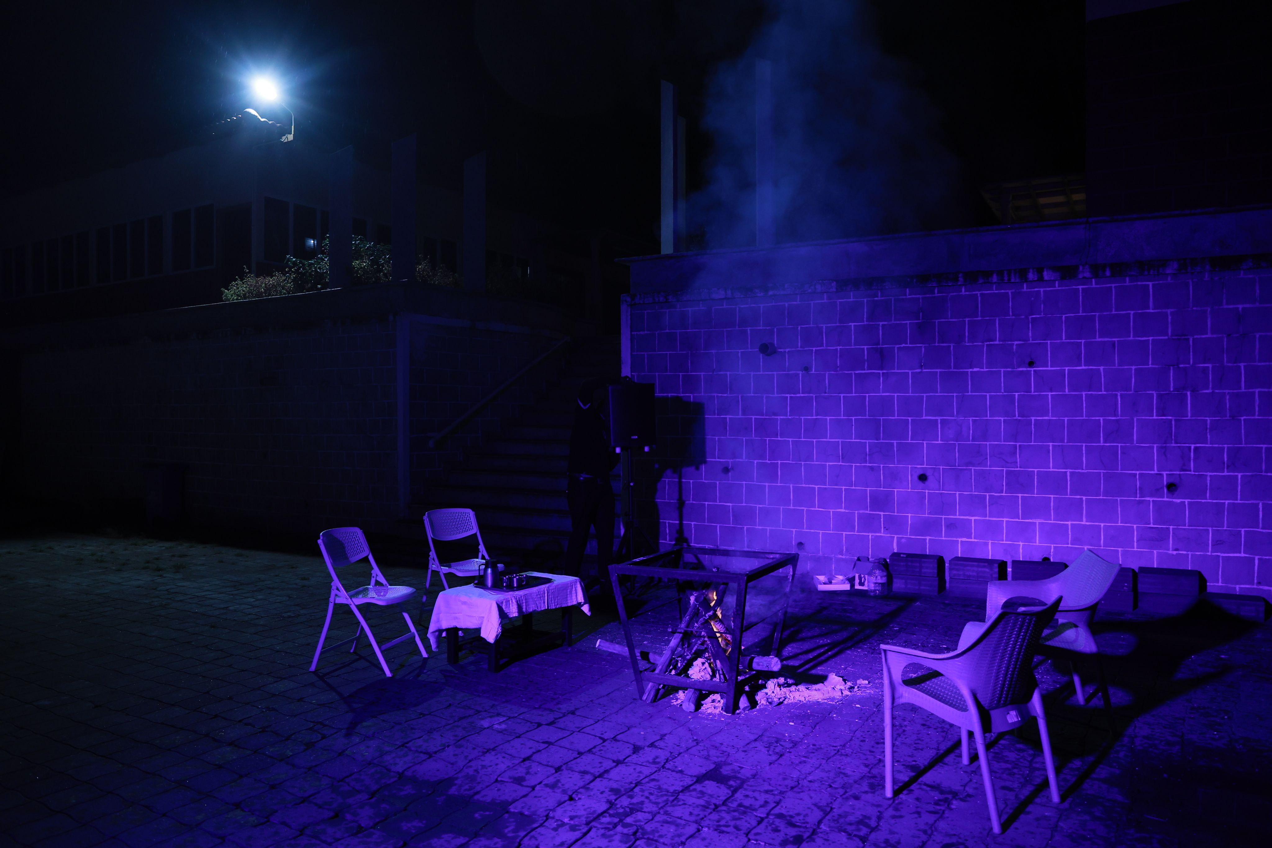 Outdoor bonfire setup with comfortable seating for guests at a luxury resort during the evening.
