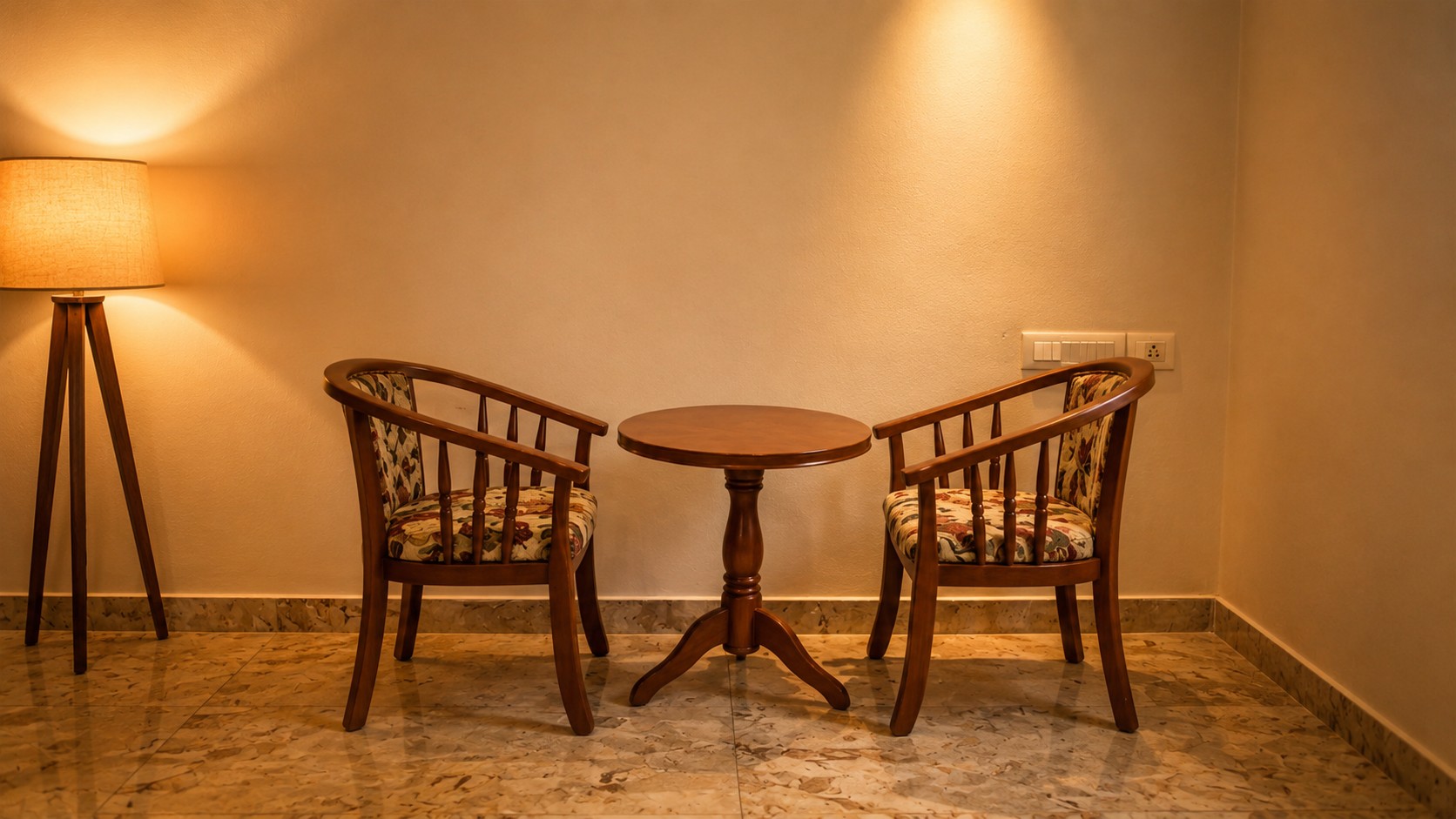 Cozy indoor seating area with wooden chairs, round table, and warm ambient lighting in a luxury resort