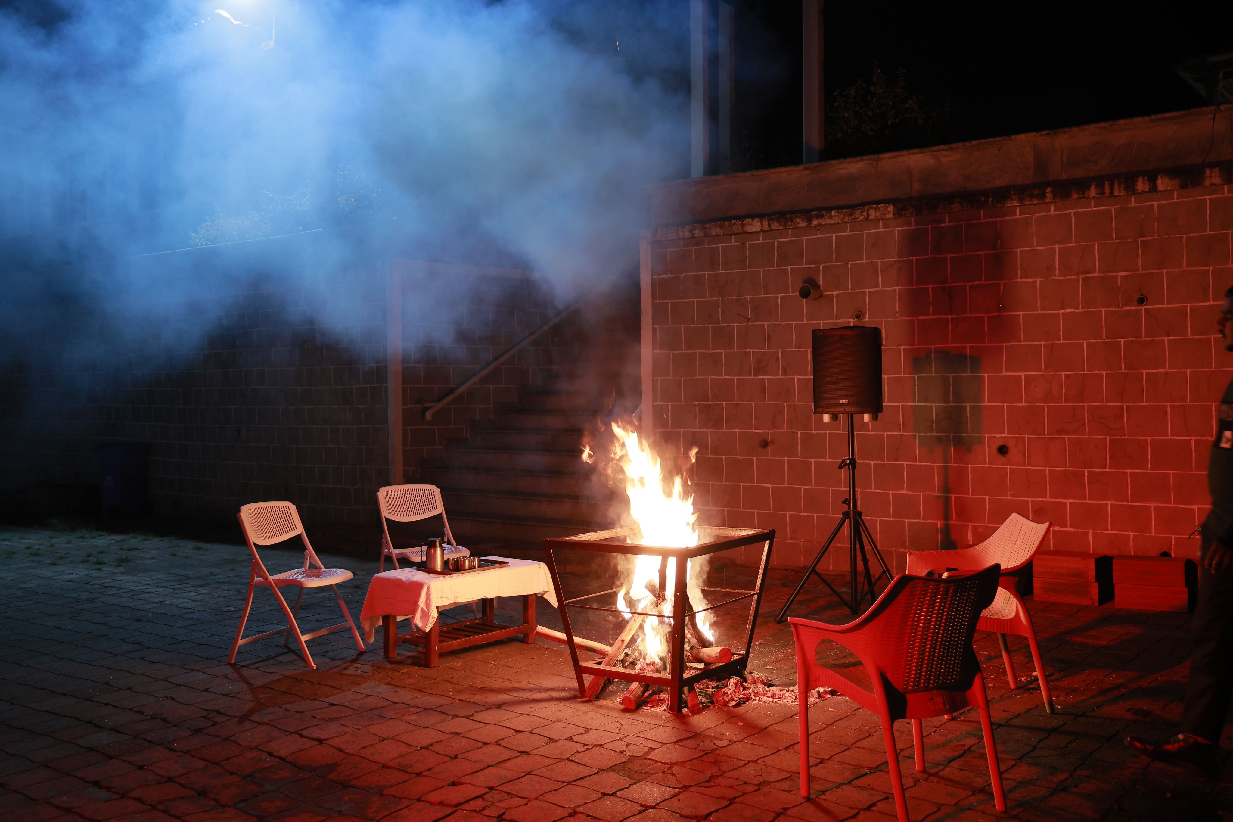 Outdoor bonfire setup at a luxury resort with cozy seating for evening gatherings and campfire experiences