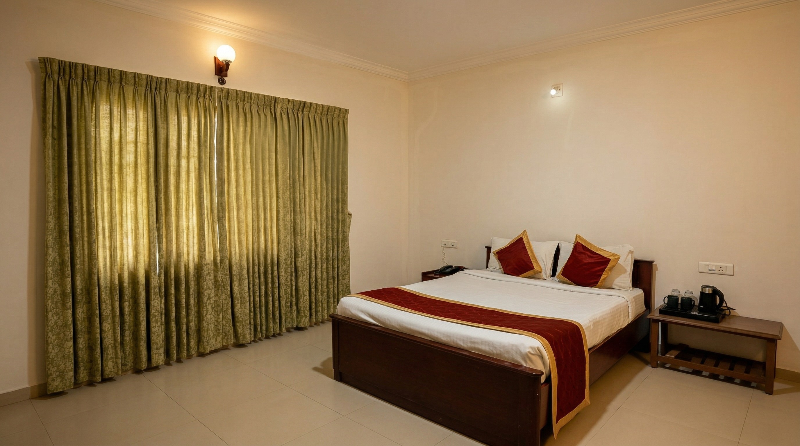 Deluxe hotel room with private patio, outdoor seating, and garden view at a luxury hillside resort.